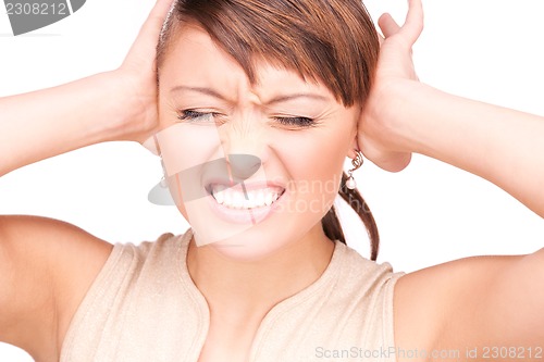 Image of unhappy woman with hands on ears