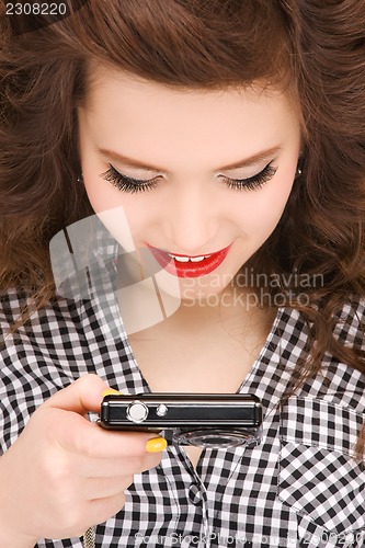 Image of happy teenage girl with digital camera