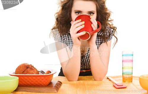 Image of young attractive woman in the kitchen