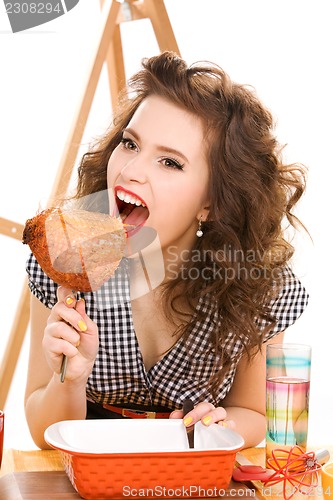 Image of young attractive woman in the kitchen