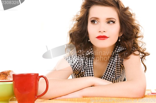 Image of young attractive woman in the kitchen