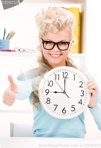 Image of woman holding big clock