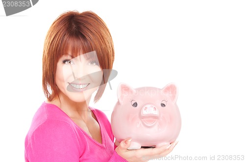Image of lovely woman with piggy bank  