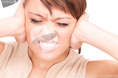 Image of unhappy woman with hands on ears