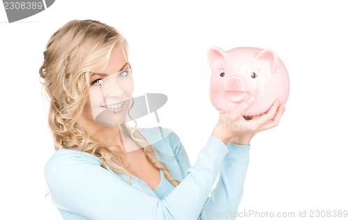 Image of lovely woman with piggy bank