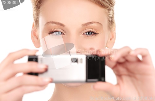 Image of happy woman using phone camera