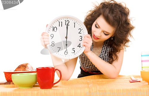 Image of young attractive woman in the kitchen