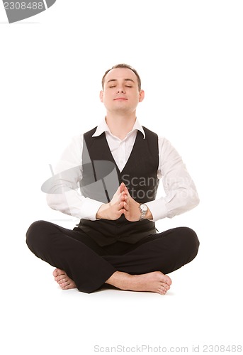 Image of businessman sitting in lotus pose
