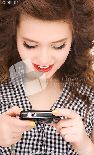 Image of happy teenage girl with digital camera