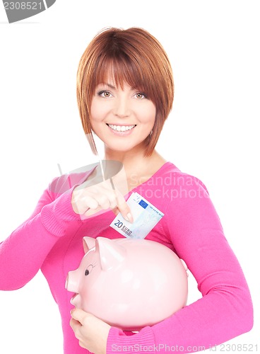 Image of lovely woman with piggy bank and money