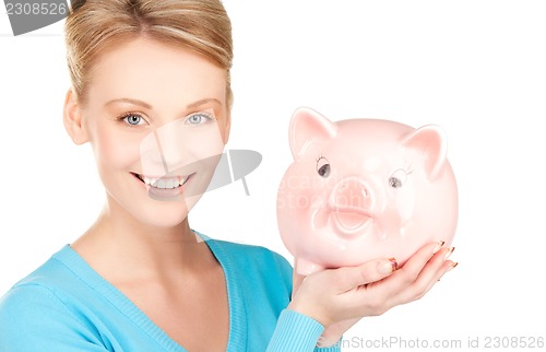 Image of lovely woman with piggy bank