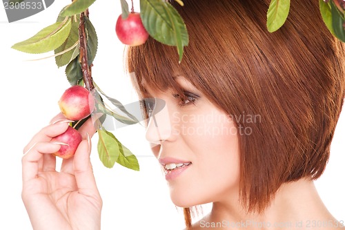 Image of happy woman with apple twig