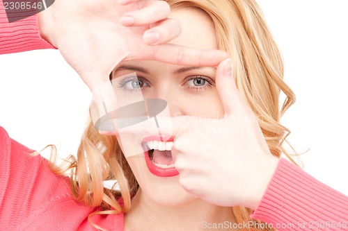 Image of lovely woman creating a frame with fingers