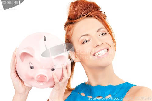 Image of lovely woman with piggy bank