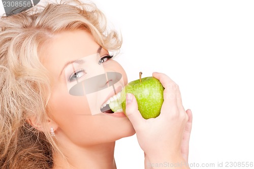 Image of young beautiful woman with green apple