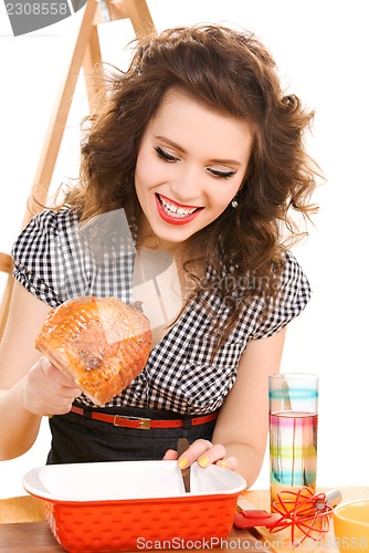 Image of young attractive woman in the kitchen
