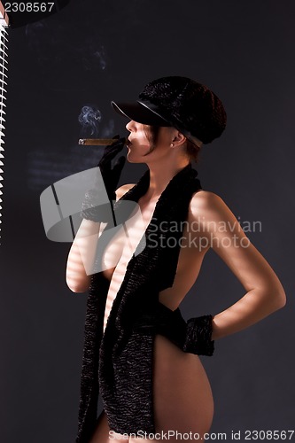 Image of woman in black astrakhan smoking cigar