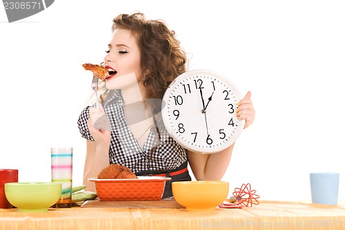 Image of young attractive woman in the kitchen