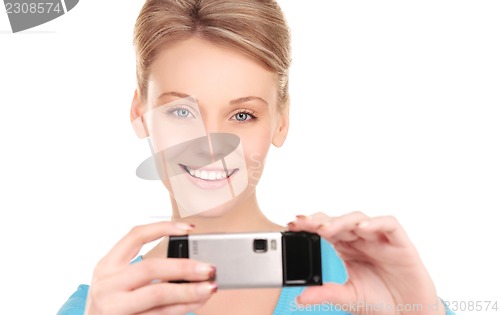 Image of happy woman using phone camera