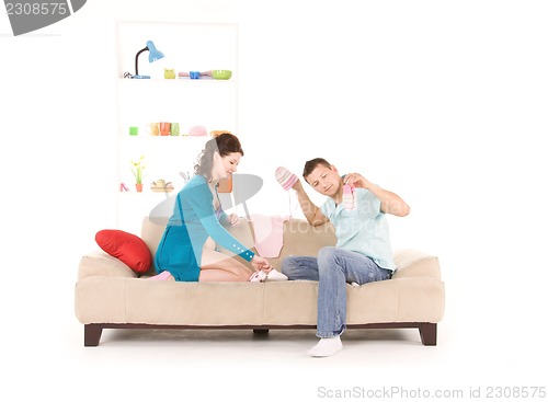 Image of happy couple with childrens clothing