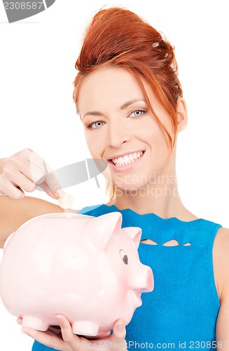 Image of lovely woman with piggy bank