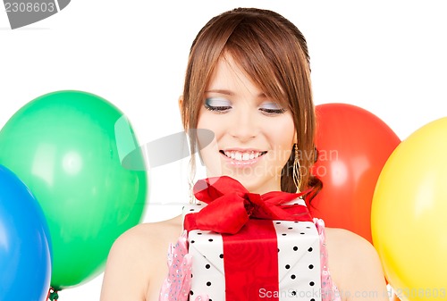 Image of party girl with balloons and gift box