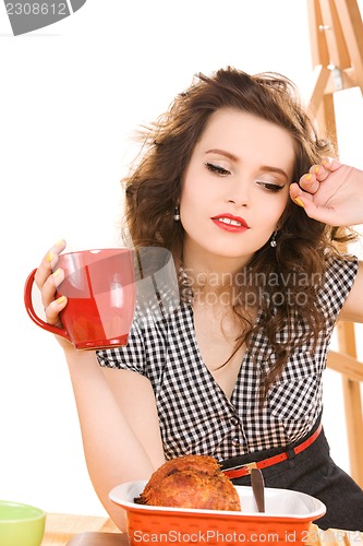 Image of young attractive woman in the kitchen