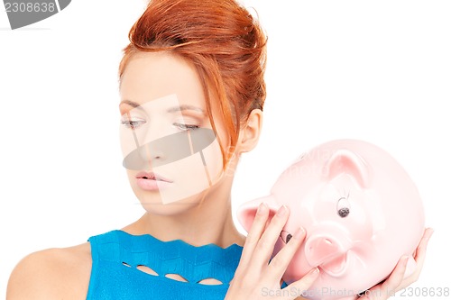 Image of lovely woman with piggy bank