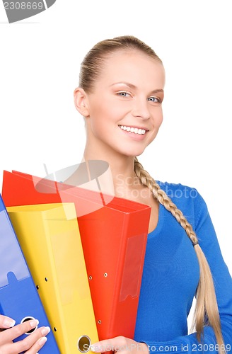 Image of young attractive businesswoman with folders