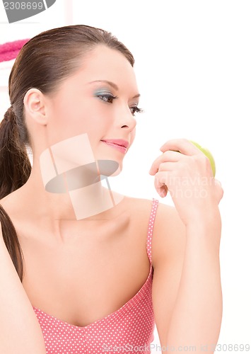 Image of young beautiful woman with green apple