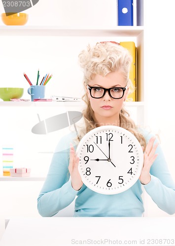 Image of woman holding big clock