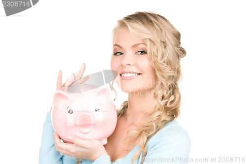 Image of lovely woman with piggy bank