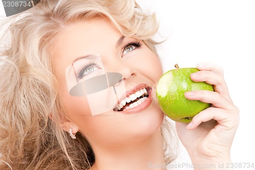 Image of young beautiful woman with green apple