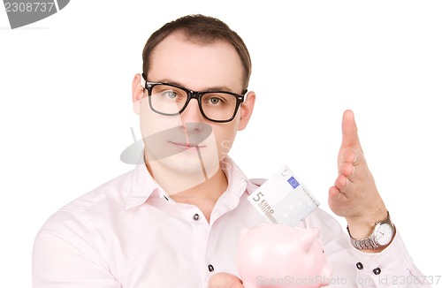 Image of businessman with piggy bank and money