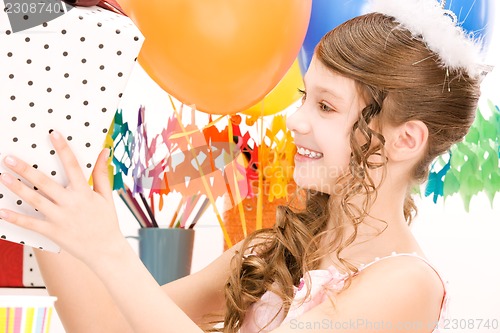 Image of party girl with balloons and gift box