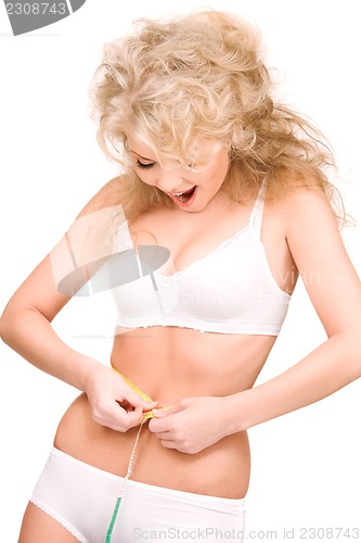 Image of young beautiful woman with measure tape