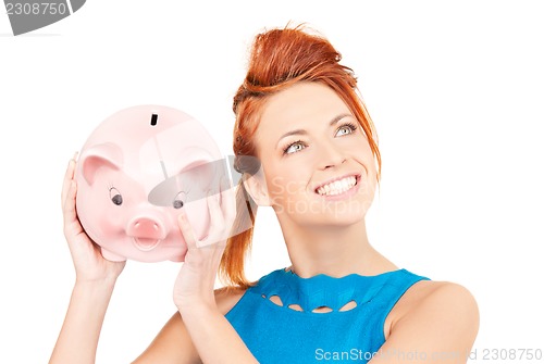 Image of lovely woman with piggy bank