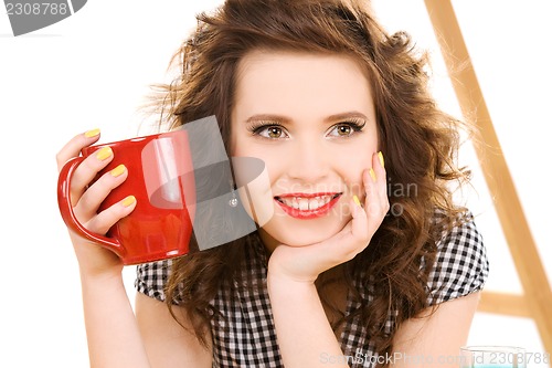 Image of young attractive woman in the kitchen