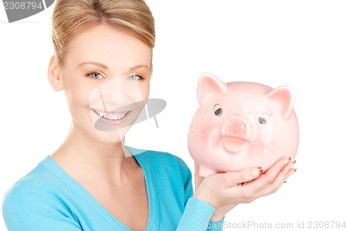 Image of lovely woman with piggy bank