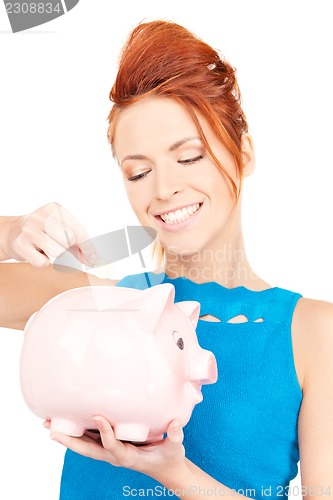 Image of lovely woman with piggy bank