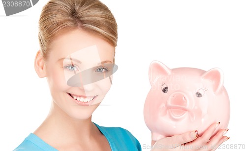 Image of lovely woman with piggy bank