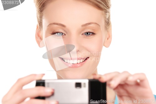 Image of happy woman using phone camera