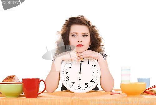 Image of young attractive woman in the kitchen