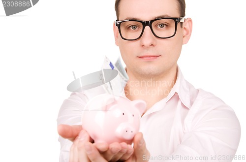 Image of businessman with piggy bank and money