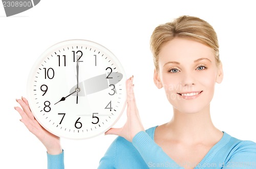 Image of woman holding big clock