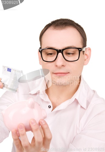 Image of businessman with piggy bank and money