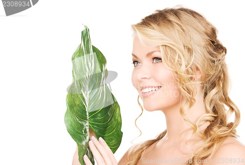 Image of woman with green leaf