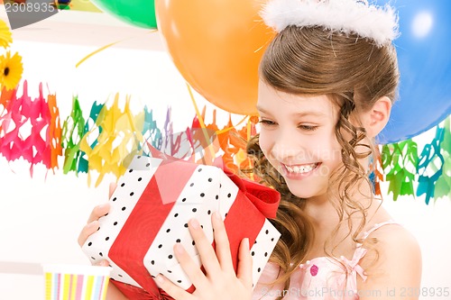 Image of party girl with balloons and gift box