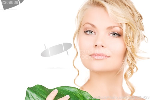 Image of woman with green leaf
