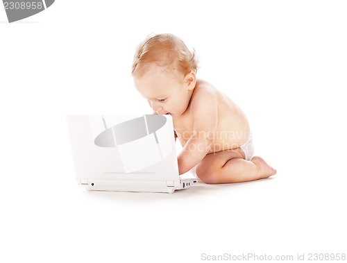 Image of baby boy in diaper with laptop computer